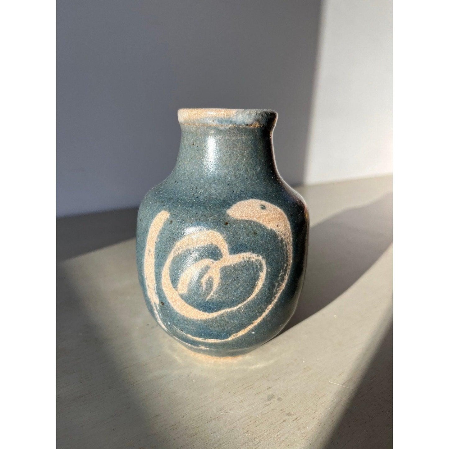 Vintage blue pottery vase with white ornaments