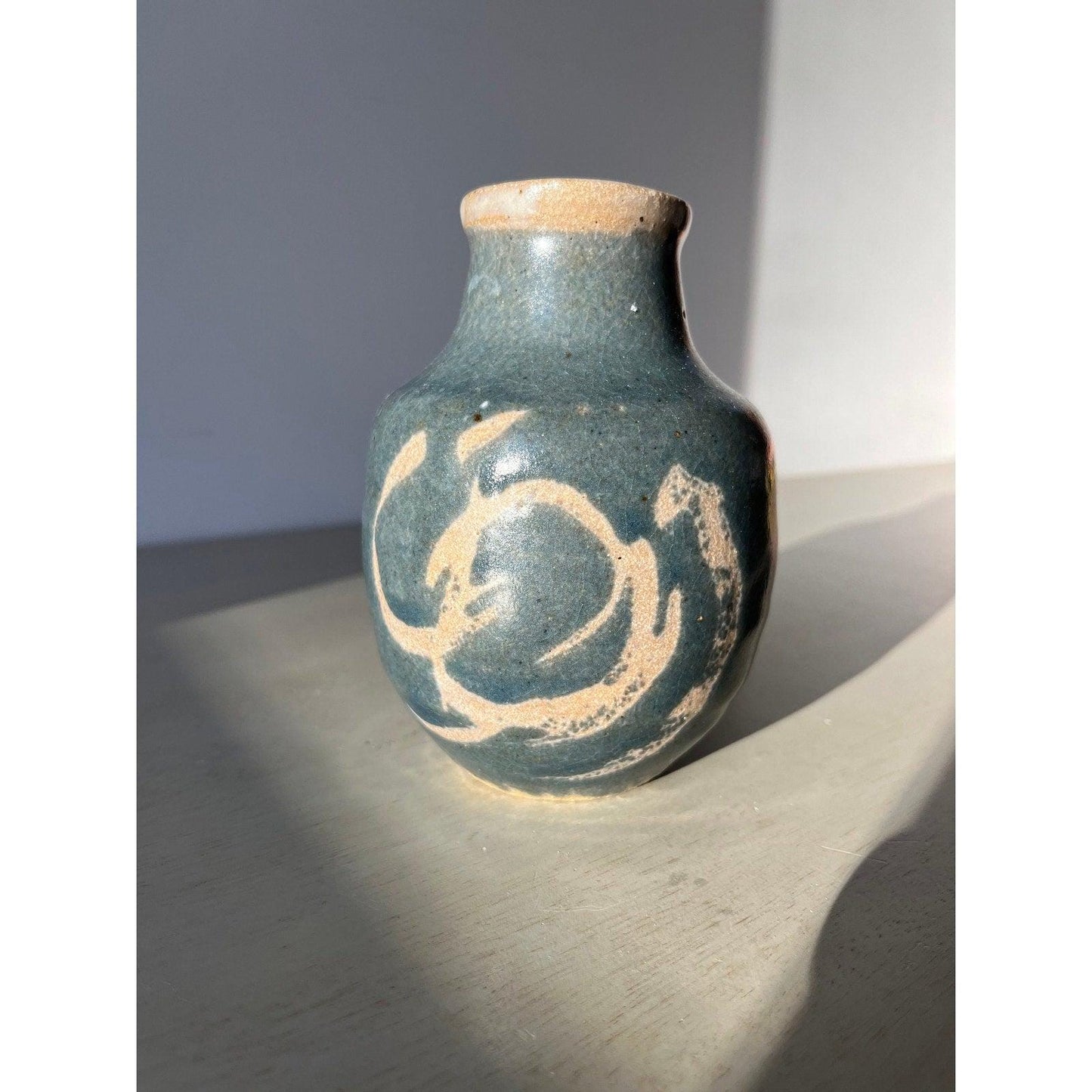 Vintage blue pottery vase with white ornaments