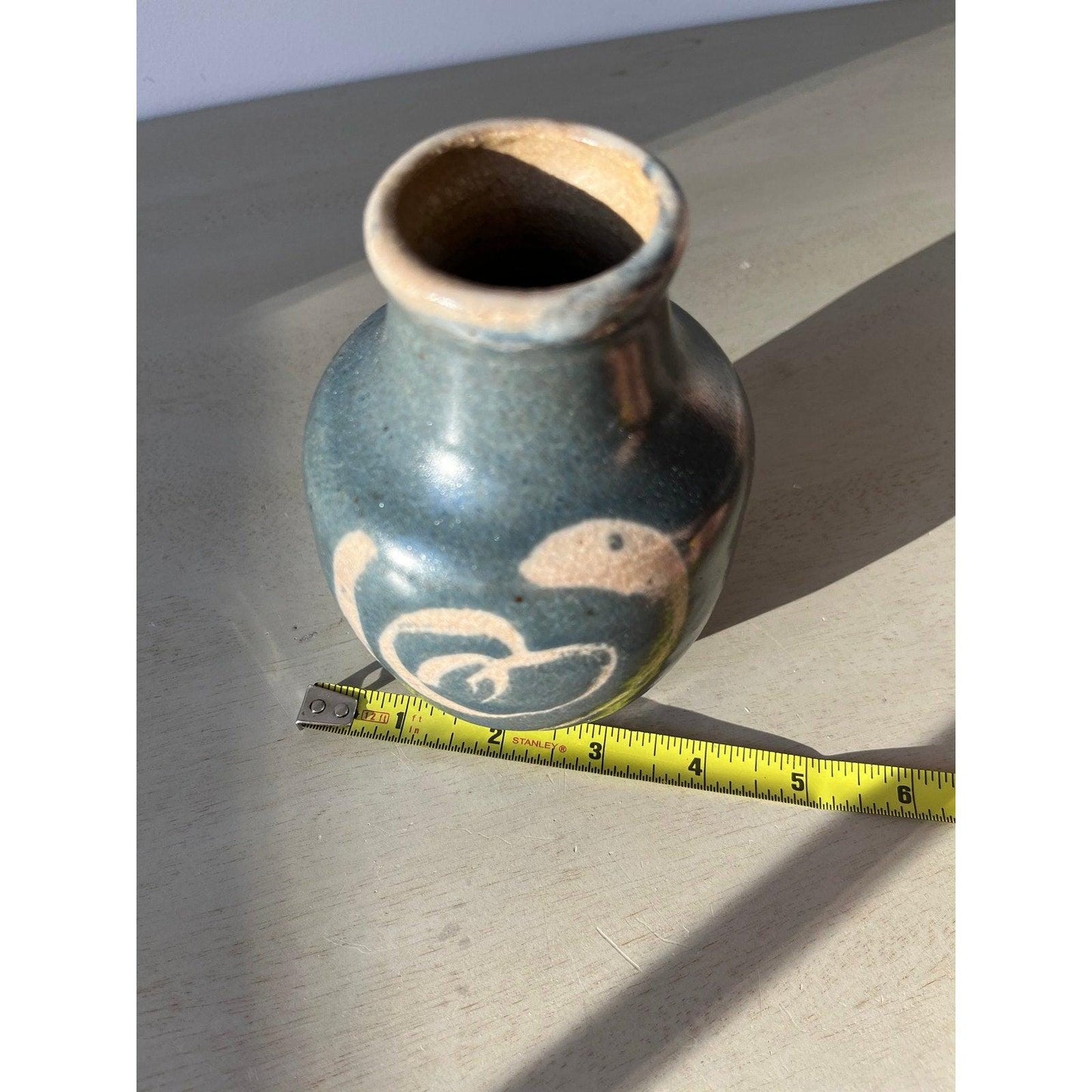 Vintage blue pottery vase with white ornaments