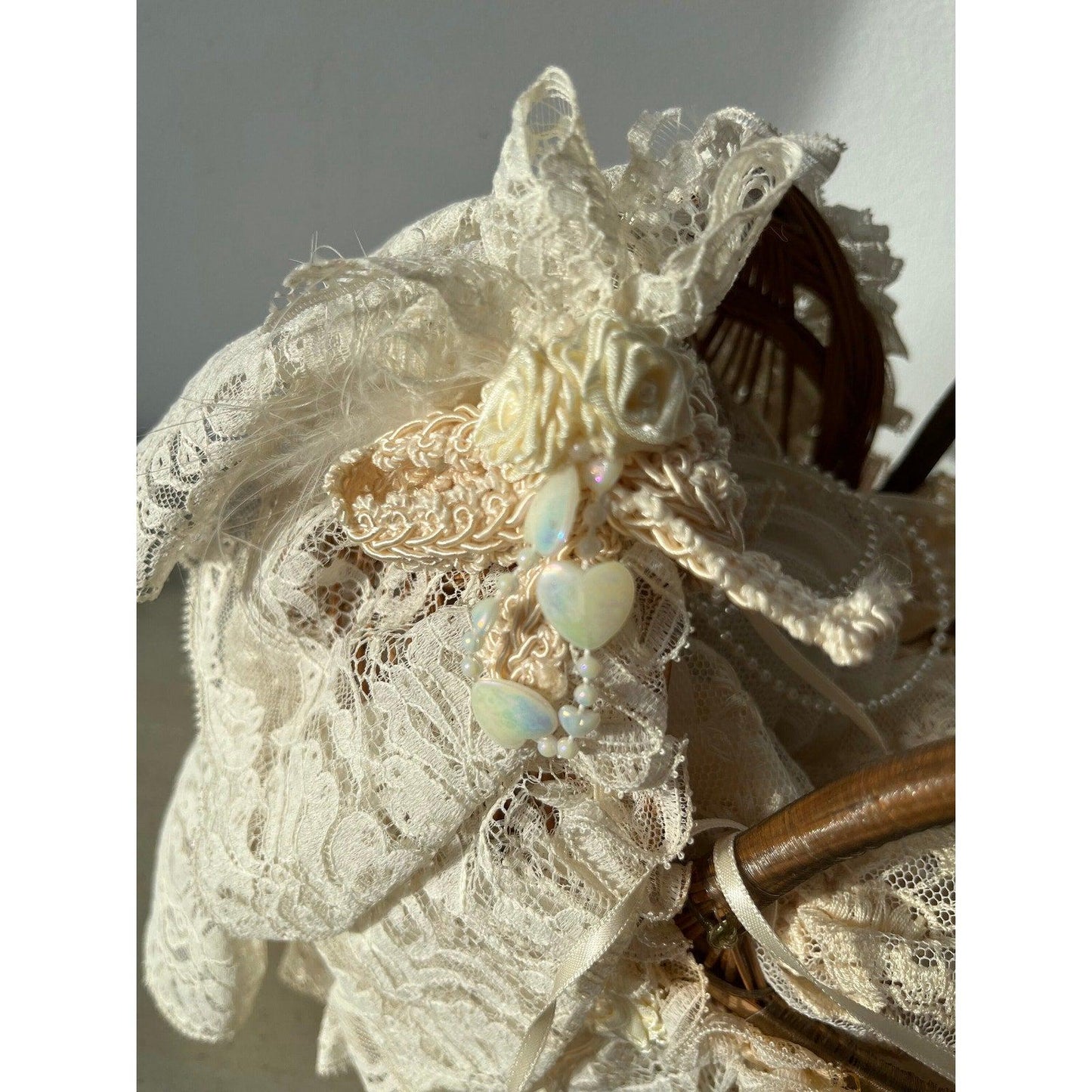 Vintage doll in a wicker basket with lace