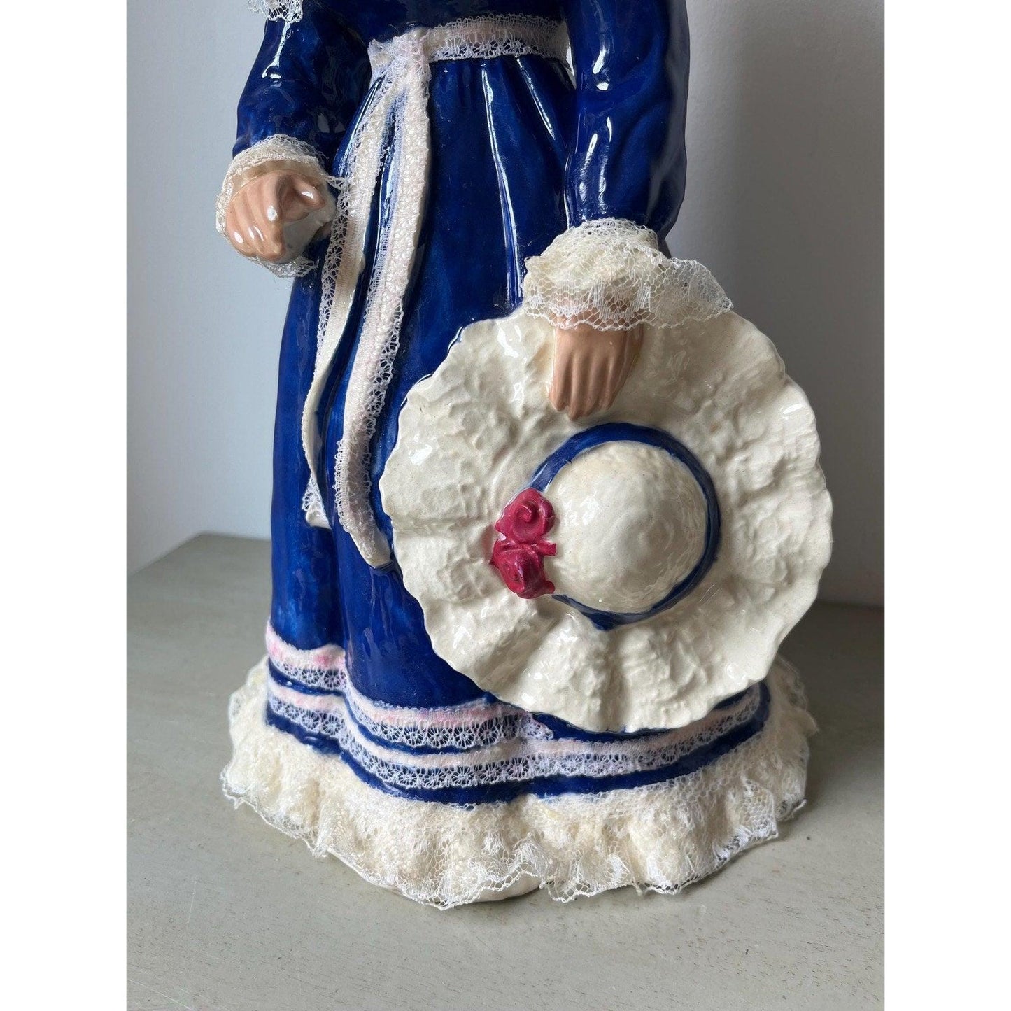 Vintage 14" ceramic figurine of a girl with a hat