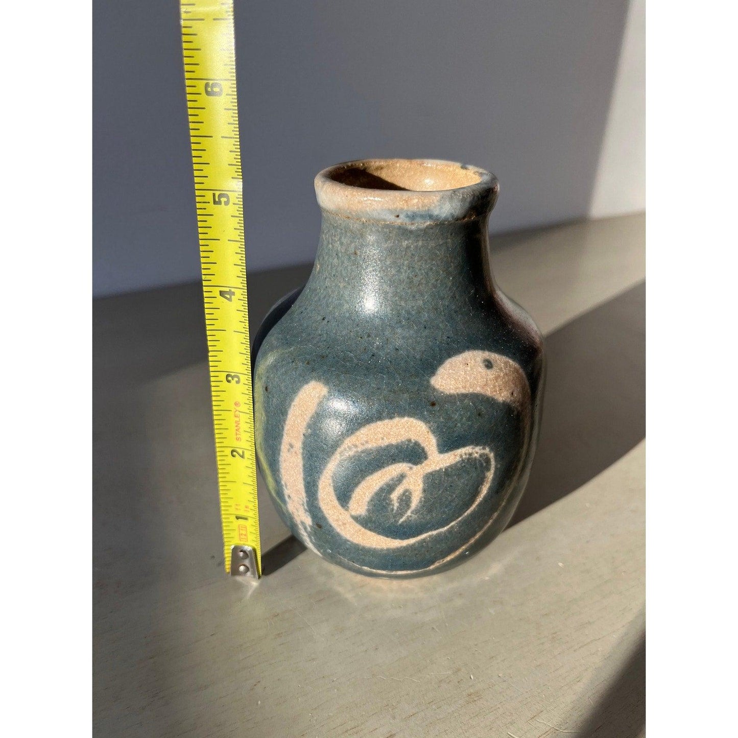 Vintage blue pottery vase with white ornaments