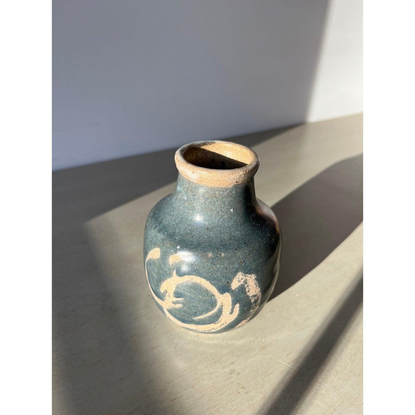 Vintage blue pottery vase with white ornaments