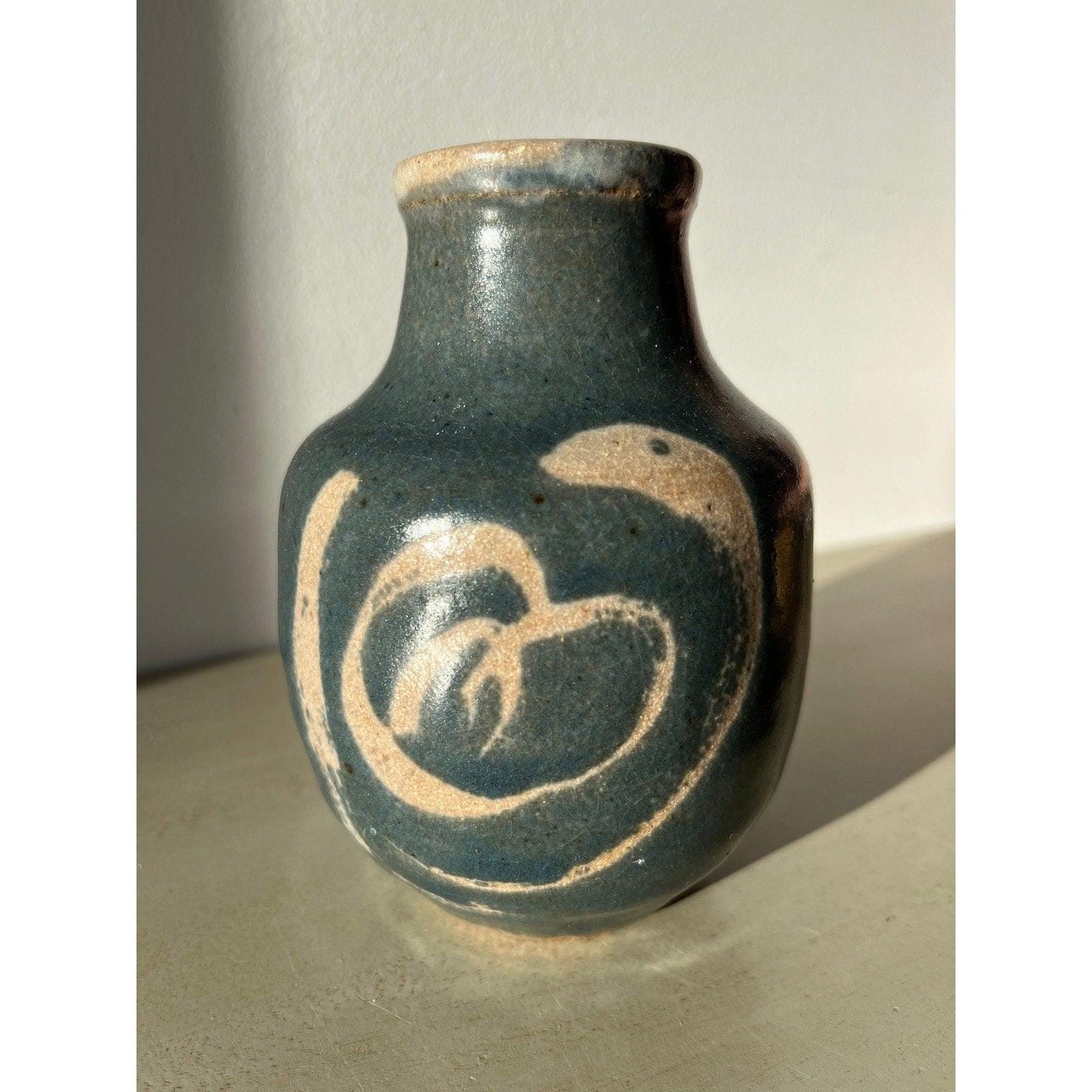 Vintage blue pottery vase with white ornaments