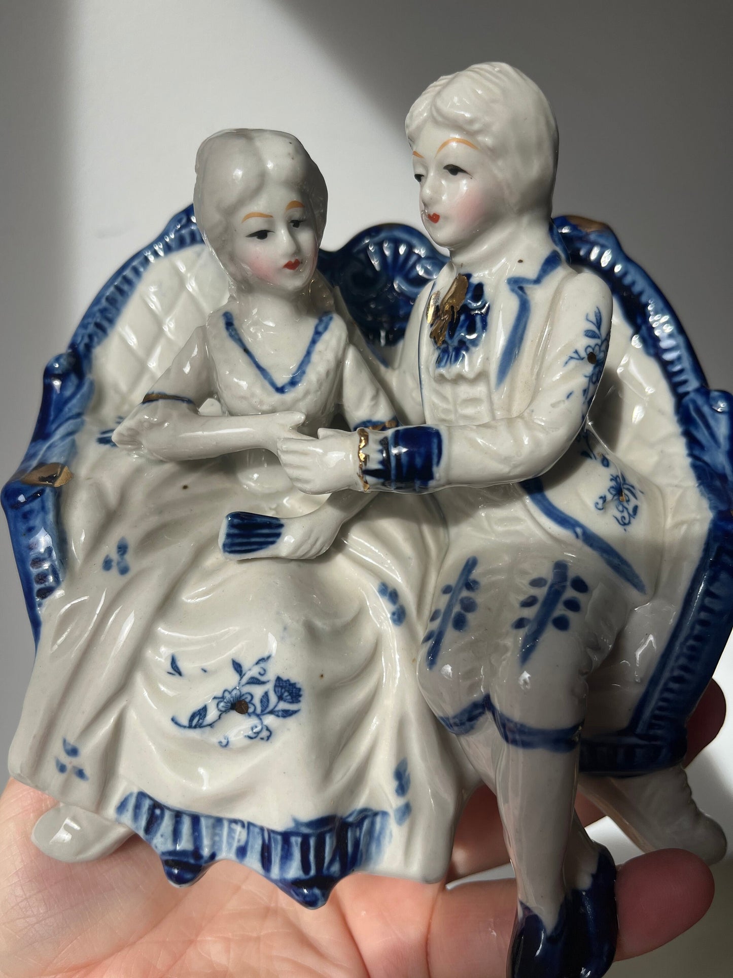 Vintage porcelain blue and white figurine of a courting 18th century couple
