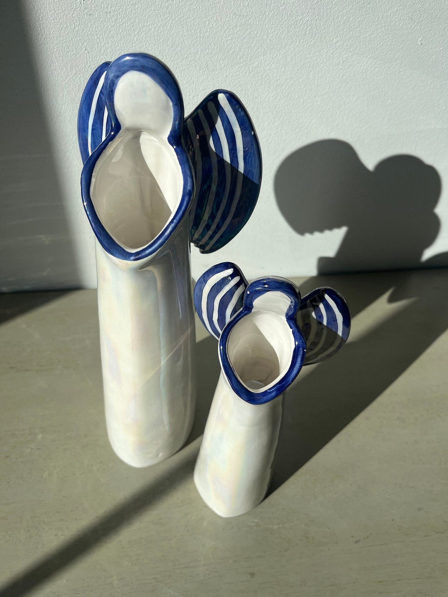 Pair of vintage iridescent glass blue pearl 12 & 9.5 inch angel candle holders