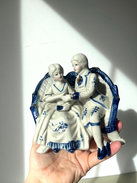 Vintage porcelain blue and white figurine of a courting 18th century couple