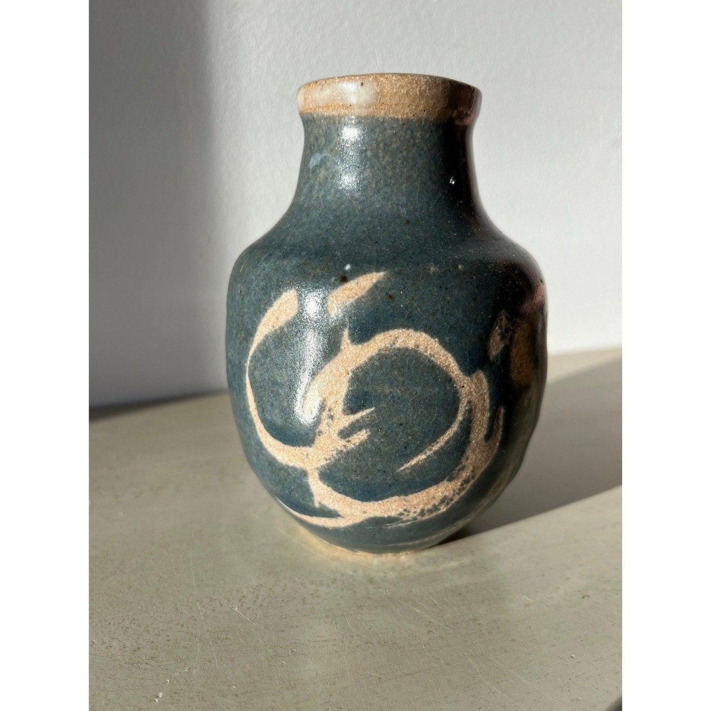 Vintage blue pottery vase with white ornaments