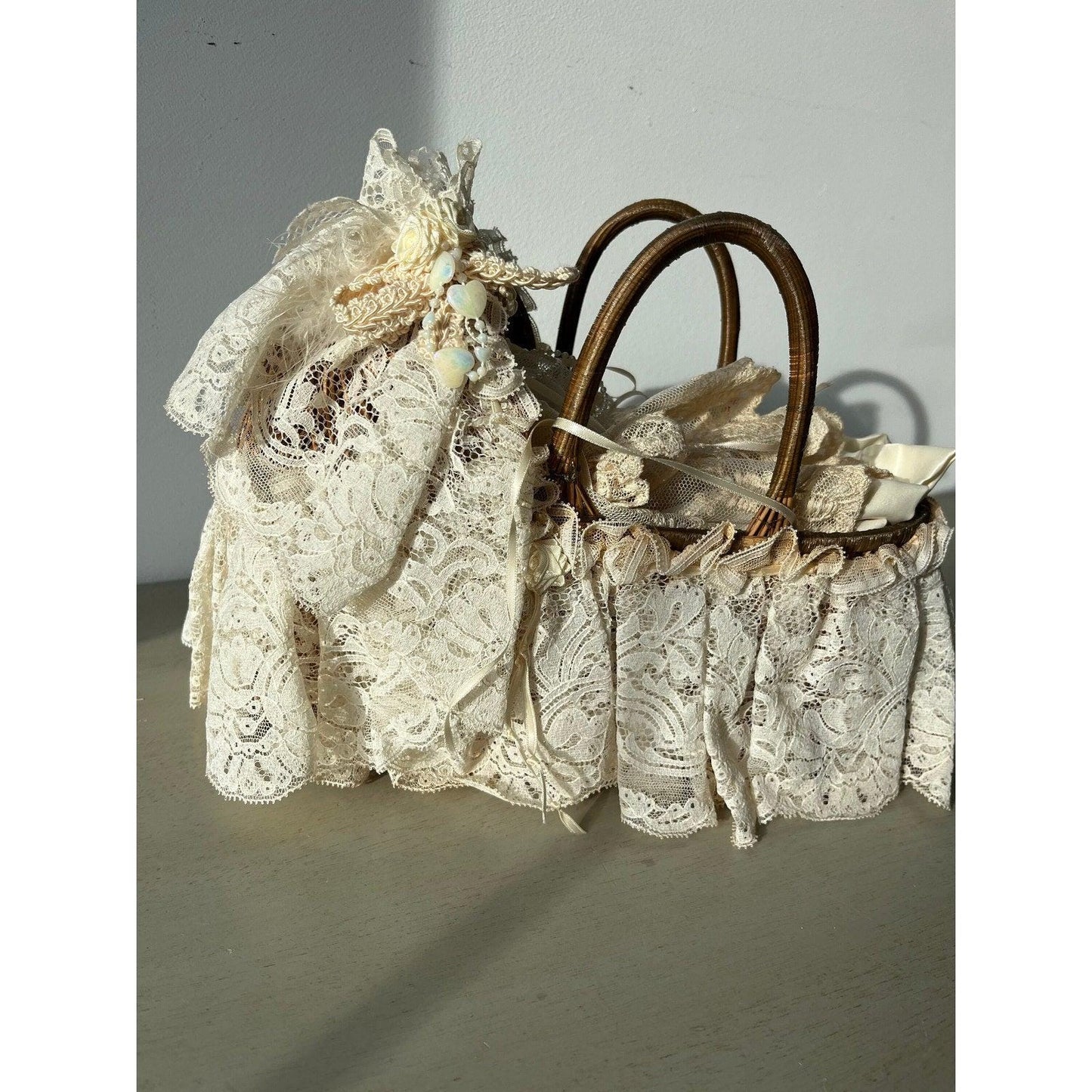 Vintage doll in a wicker basket with lace
